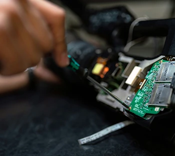 Hand with Screwdriver Repair Circuit board